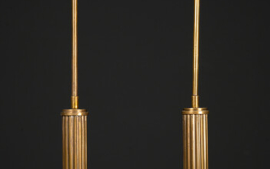 A pair of circular brass table lamps