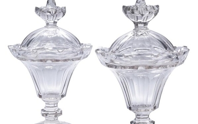 A pair of crystal sweetmeat jars, early 19th century, each with faceted rims and panelled body and cover, atop knopped stem and circular thick base, each 32cm high (2)