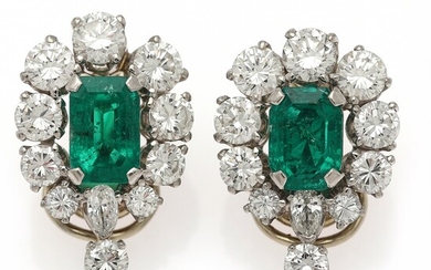 A pair of ear clips each set with an emerald encircled by numerous diamonds, mounted in platinum and 18k gold. (2)