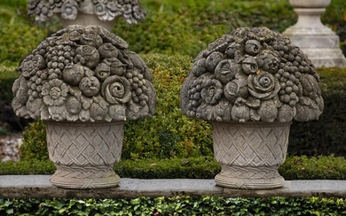 A pair of large Continental carved limestone baskets of flowers and fruit in 18th century style