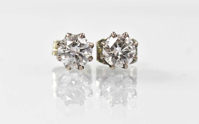 A pair of white metal diamond stud earrings, each claw...