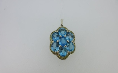 A pendant set with a cluster of blue topaz and yellow