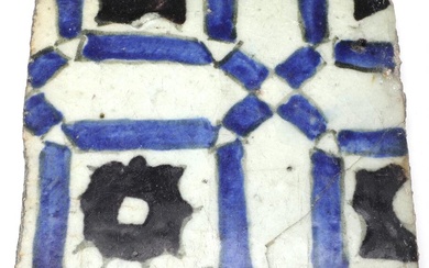 A pottery tile decorated with design in blue, black and mauve, Syria...