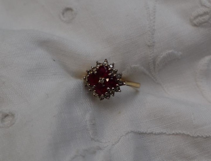 A ruby and diamond cluster ring, set with four...