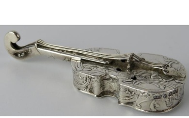 A silver box in the form of a violin with embossed decoratio...