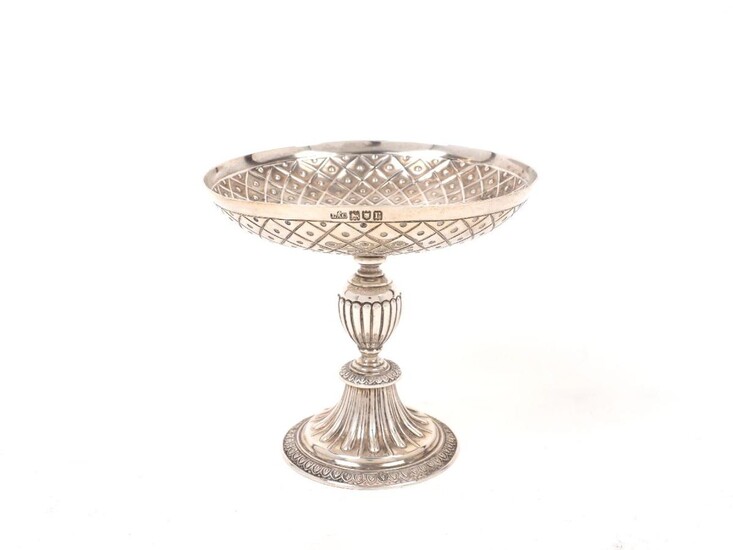 A small George V silver tazza, London, 1912, Crichton Brothers, the geometric repousse patterned bowl to a lobed, baluster stem and spreading circular foot, 12cm high, approx. weight 7.7oz