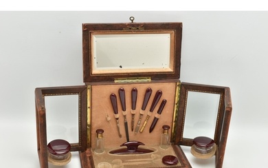 AN EARLY 20TH CENTURY TOOLED LEATHER AND GLAZED MANICURE CAB...