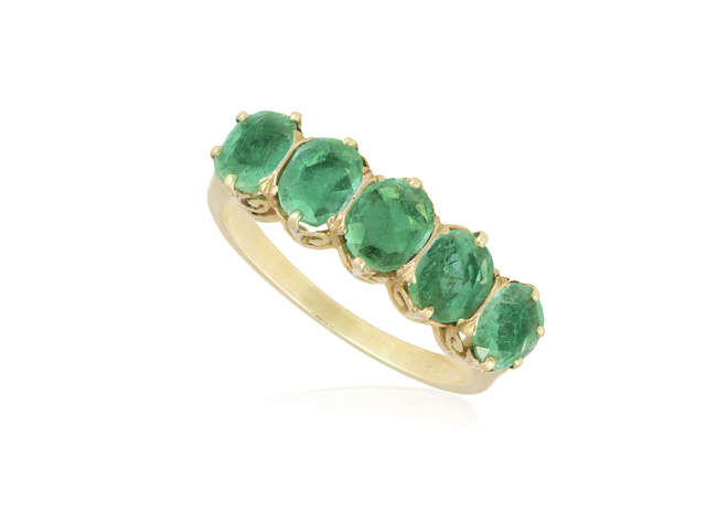 AN EMERALD FIVE-STONE RING Set with a graduated...