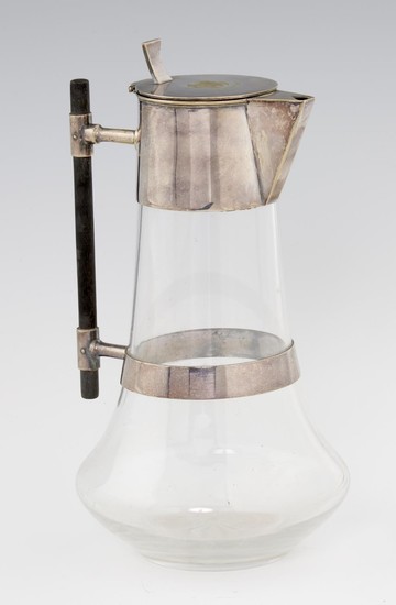 AN EPNS MOUNTED GLASS CLARET JUG BASED ON A DESIGN BY DR CHR...