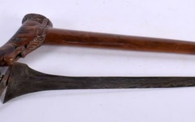 AN UNUSUAL 18TH CENTURY DUTCH CARVED FRUITWOOD CASED KRISS DAGGER with seaweed affect blade, the han