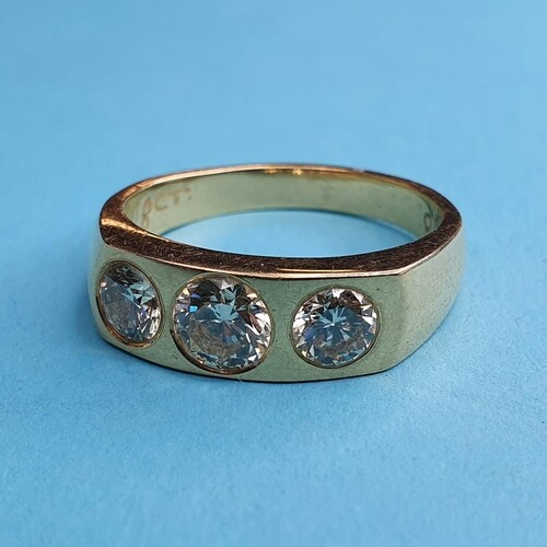 An 18ct gold and three stone diamond gypsy set ring, ring si...