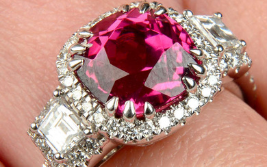 An 18ct gold pink tourmaline ring, with fancy-shape diamond sides and brilliant-cut diamond surrounds.