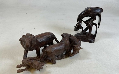 An African carved wooden group of animals, lions and a...