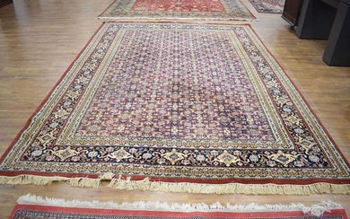 An Iranian carpet, the ground with repeated red, blue and...