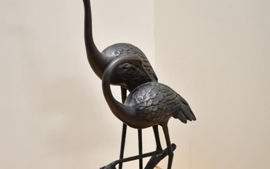 An appealing 20th century cast and patinated-metal ornithological sculpture, modelled as two