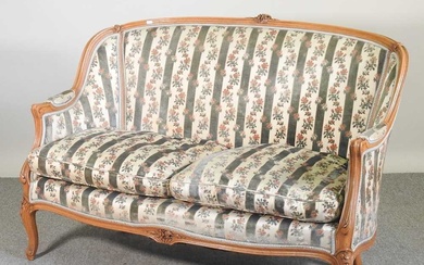 An early 20th century French show frame sofa, with striped...