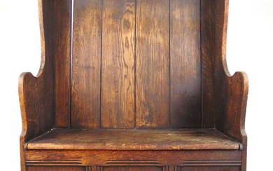 An early 20th century oak box settle, the back over...