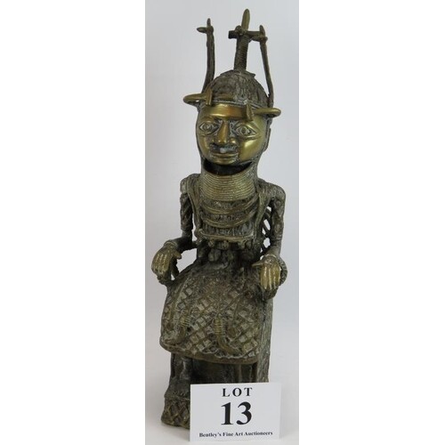 An ethnic Benin bronze figure of a seated oba with ceremonia...