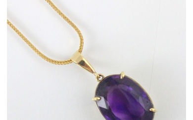 An untested amethyst set pendant, the oval cut stone within ...