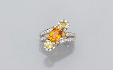 Beautiful white gold ring, 750 MM, centered on an oval orange sapphire weighing 1.44 carat, Ceylon origin between two round yellow sapphires worn by four lines of diamonds, GGT laboratory certificate, size: 52, weight: 5.6gr. rough.