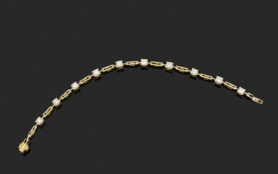 Bracelet articulé en or jaune 18K à décor de maillons stylisés rythmé de dix diamants,...