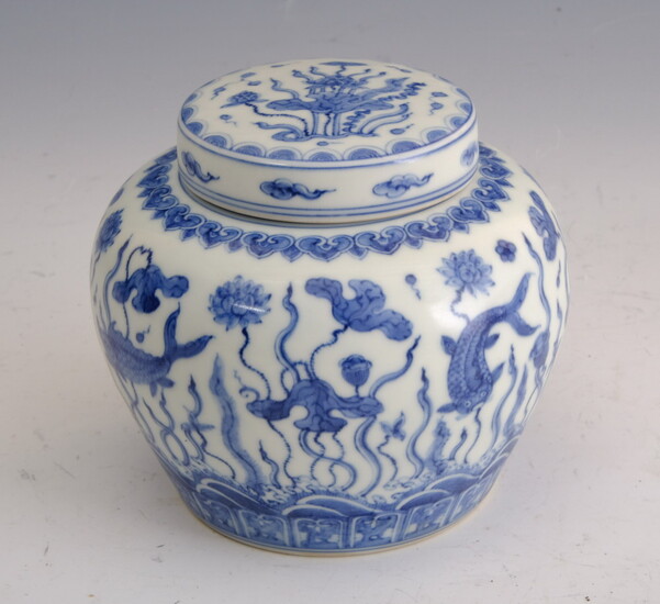 CHINESE BLUE AND WHITE PORCELAIN LIFT-COVER JAR. Carp swimming amidst...
