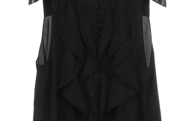 Chloé: A black sleeveless silk blouse with a high neckline, a small collar, drapings and buttons on the front. Size 42 (FR).