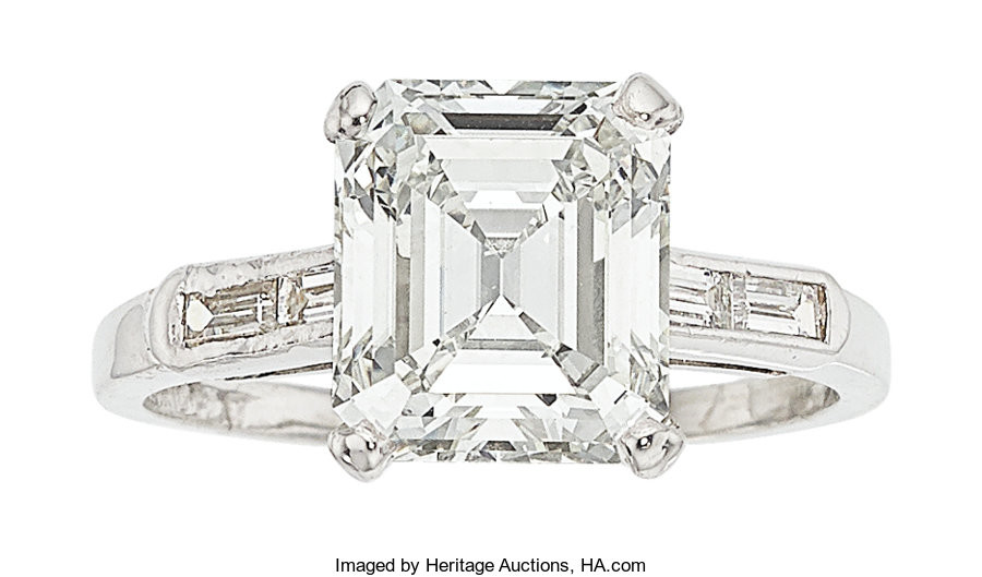 Diamond, Platinum Ring The ring features an emerald-cut diamond...
