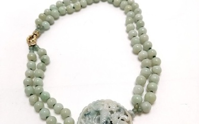 Double strand of jade beads with large pierced & hand carved...