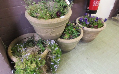 Four PVC stone effect garden planters with flowers.Condition Report There...