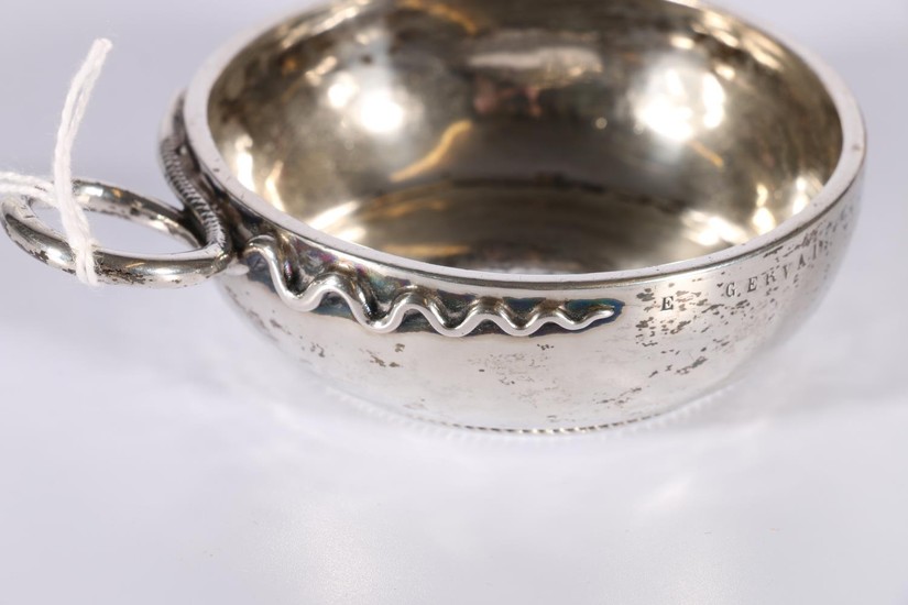 French silver tastevin of typical style, with serpent handle...