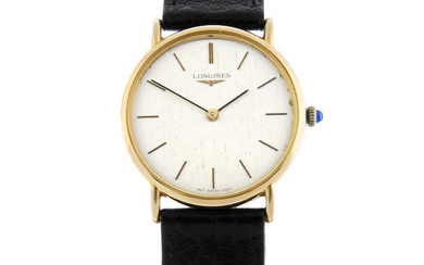 LONGINES - a 9ct yellow gold wrist watch, 32mm.