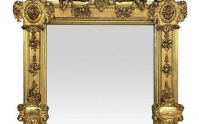 Mirror in gilded wood carved with garlands of fruit and