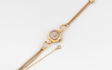 Montre bracelet de dame en or jaune (750). Boîtier rond. Cadran à fond argenté, index...