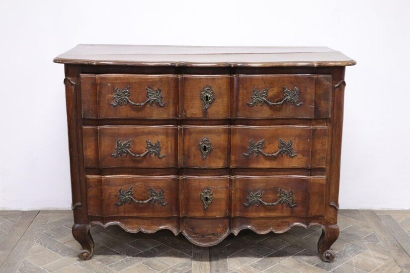 Moulded and carved wooden crossbow chest of drawers with three drawers.