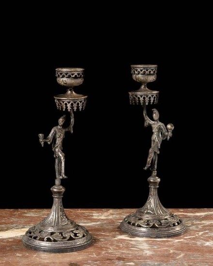 Pair of silver plated metal torches resting on a round openwork base, the was in the form of figures holding a parasol with mantling forming a bobbin. Work from the Far East, early twentieth century Height: 22.5 cm