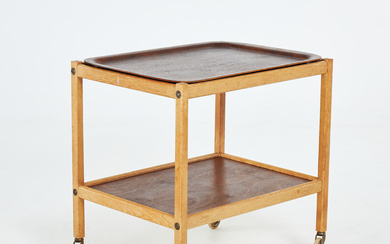 SERVING TROLLEY. Mid-20th century, oak and birch, stained loose-lying oak tray, metal and rubber wheels.