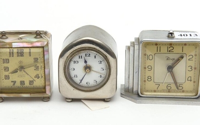 THREE TRAVEL ALARM CLOCKS, INCLUDING A FRENCH NICKEL CASED CLOCK, A FRENCH STAINLESS STEEL CASED CLOCK AND A JUNGHANS GERMAN MOTHER...