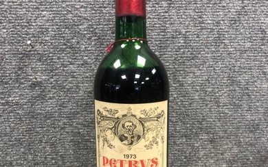 Une bouteille PETRUS, Pomerol 1973. Niveau bas épaule, étiquette légèrement déchirée et tâchée. Usures à...
