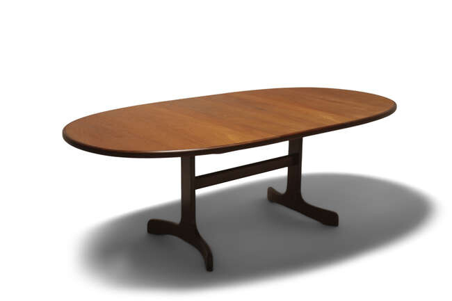 VICTOR WILKINS An oval teak extending dining table...