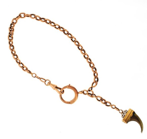 Vest chain in 18 K (750 °/°°°) pink gold with a forçat type link, holding a claw mounted on 18 K yellow gold in pendants.