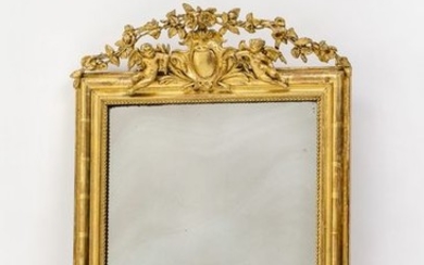 Wall mirror. Gilded frame, plastic volutes at the...