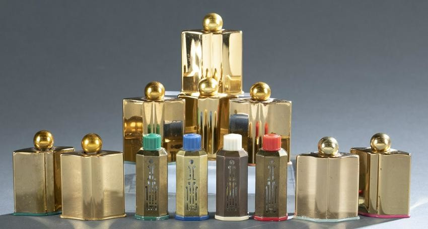 12 Coty brass covered perfume bottles.