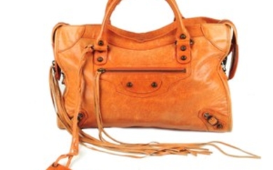 BALENCIAGA - an orange Classic City handbag. View more details