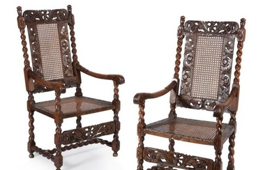A pair of Charles II caved walnut armchairs