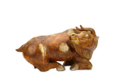 A CHINESE POTTERY MODEL OF A BULL. The...