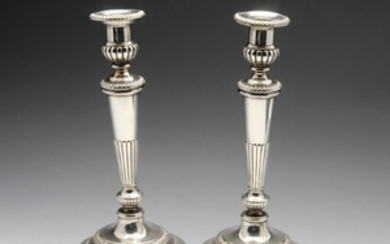 A pair of George III silver candlesticks, each with a