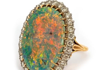 An opal and diamond cluster ring, the large oval opal