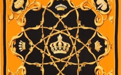 1918/1214 - Hermès: A silk scarf in black and orange nuances. 90 x 90 cm.