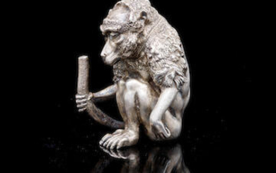 A silver lighter modelled as a seated Baboon